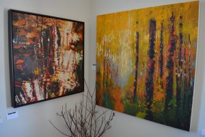 Paintings in the corner of the gallery at Black Spruce Art Works